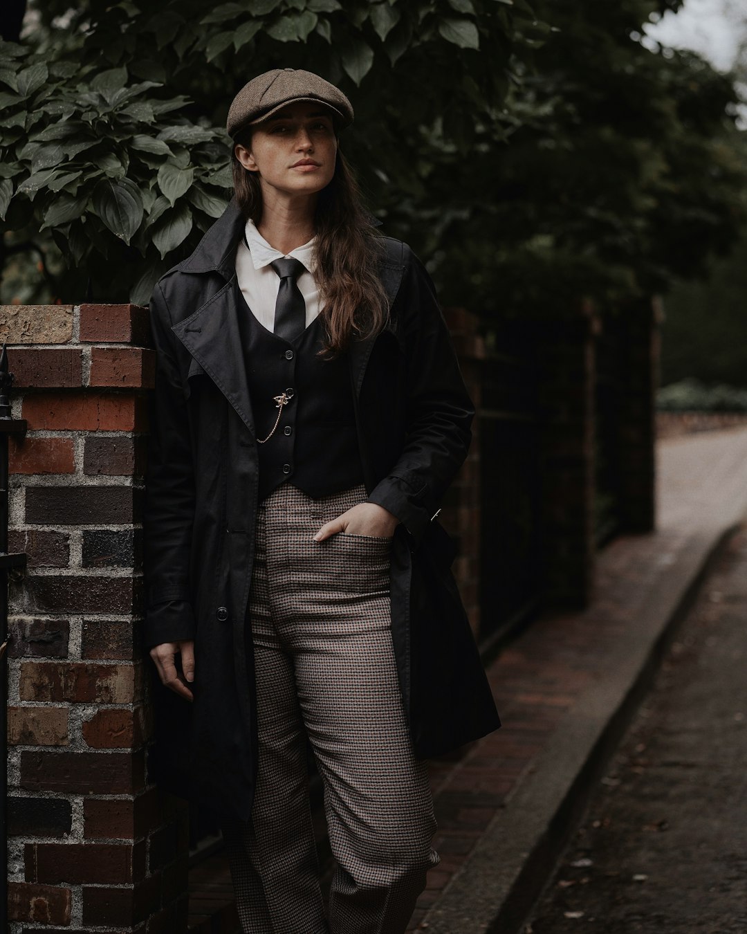 Portrait of Portland Fashion Model posing in a vest and tweed hat. Headshot taken by Lance Reis on my Sonya7iii. Drop by insta & let me know if you discovered me here. IG: kickassdesigns by Clothing Brands a woman standing next to a brick wall