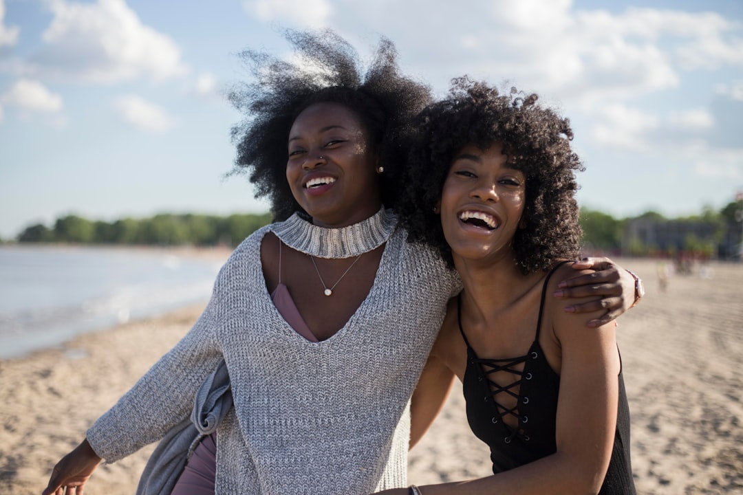 Best friends in summer on the beach girls by Clothing Brands photo of woman beside another woman at seashore