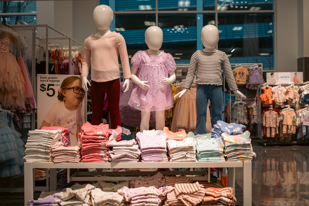 Clothing display with child mannequins at a store.